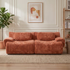 Canapé modulable chenille terracotta dans un salon aux murs moulurés